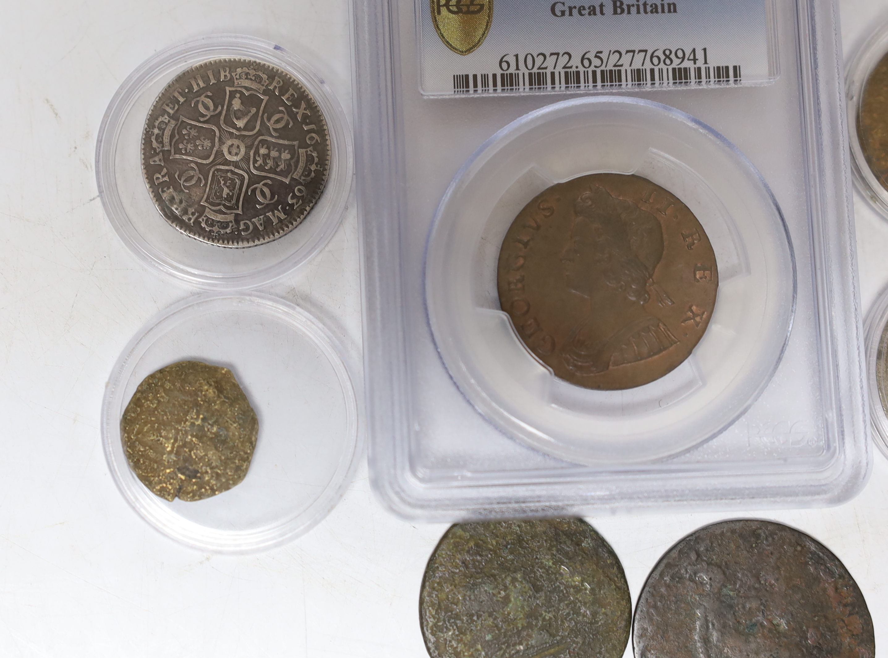 Seven coins including; a Charles II 1663 shilling, an Edward VI silver shilling, a George II 1735 half penny (PCGS graded MS65BN) together with four other coins